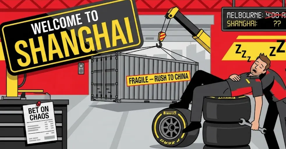 A mechanic wearing team clothing is asleep on stacked Pirelli racing tires, holding a wrench.